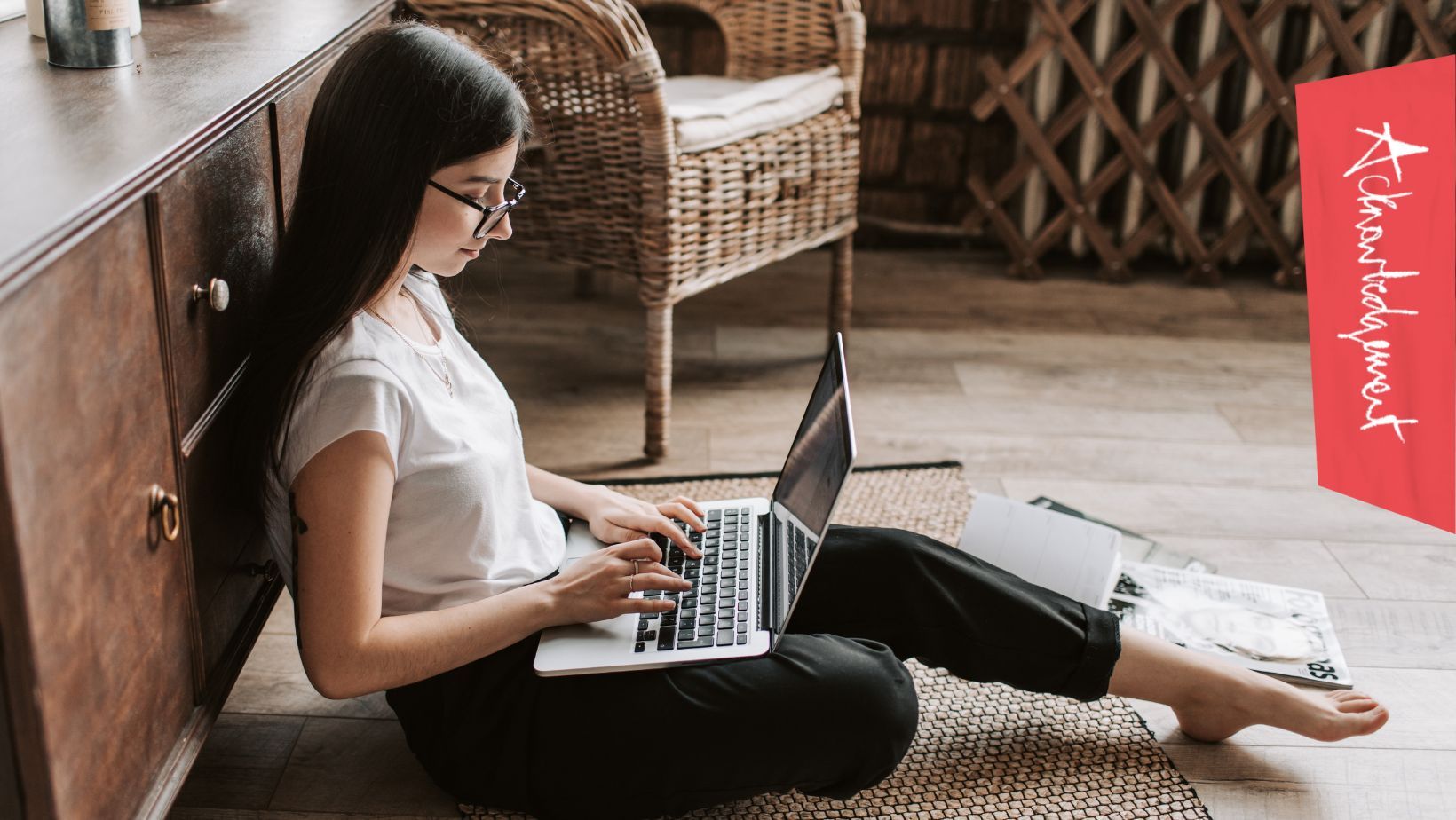 Person sitting on the floor using a laptop